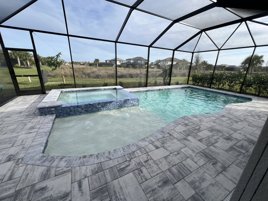 Pool and spa under lanai screen enclosure